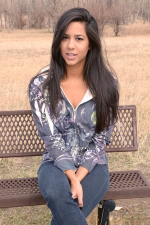 Amateur model Bella Quinn exposes black bra on an outdoor bench