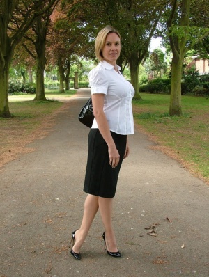 Fully clothed secretary Monica shows off hose clad legs in pumps on pathway