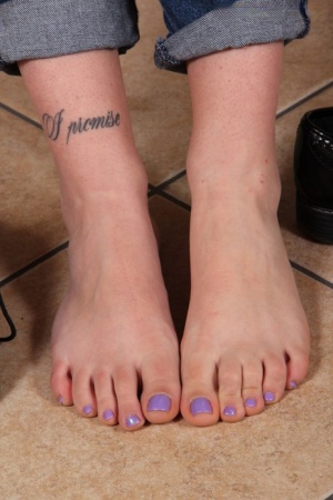 Clothed solo girl takes off shoes and socks to show her pretty feet