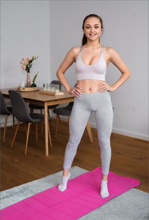 Brunette solo girl doffs spandex clothing to get naked on her yoga mat