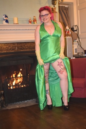 Tattooed amateur Mollie Foxxx exposes herself afore a fireplace in a dress