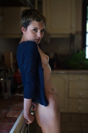 Short haired girl Caterina Foxy gets mostly naked while in her kitchen