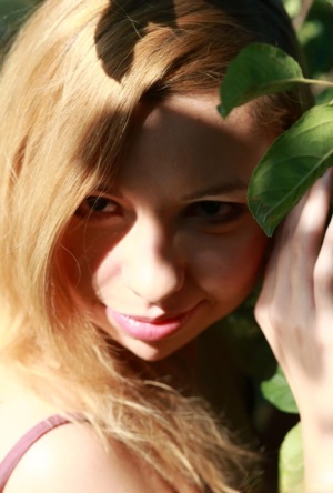 Barely legal blonde Kimberly gets naked underneath an apple tree