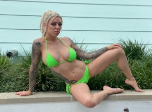 Tattooed blonde Karma Rx models a bikini before an ass licking POV blowjob