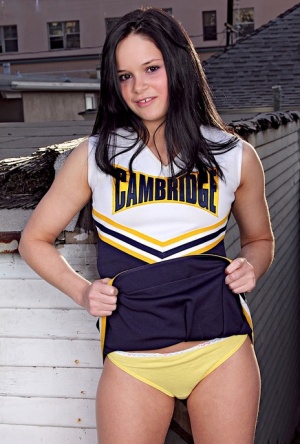 Teen cheerleader Jenna Ross doffs her uniform to pose nude on a rooftop patio