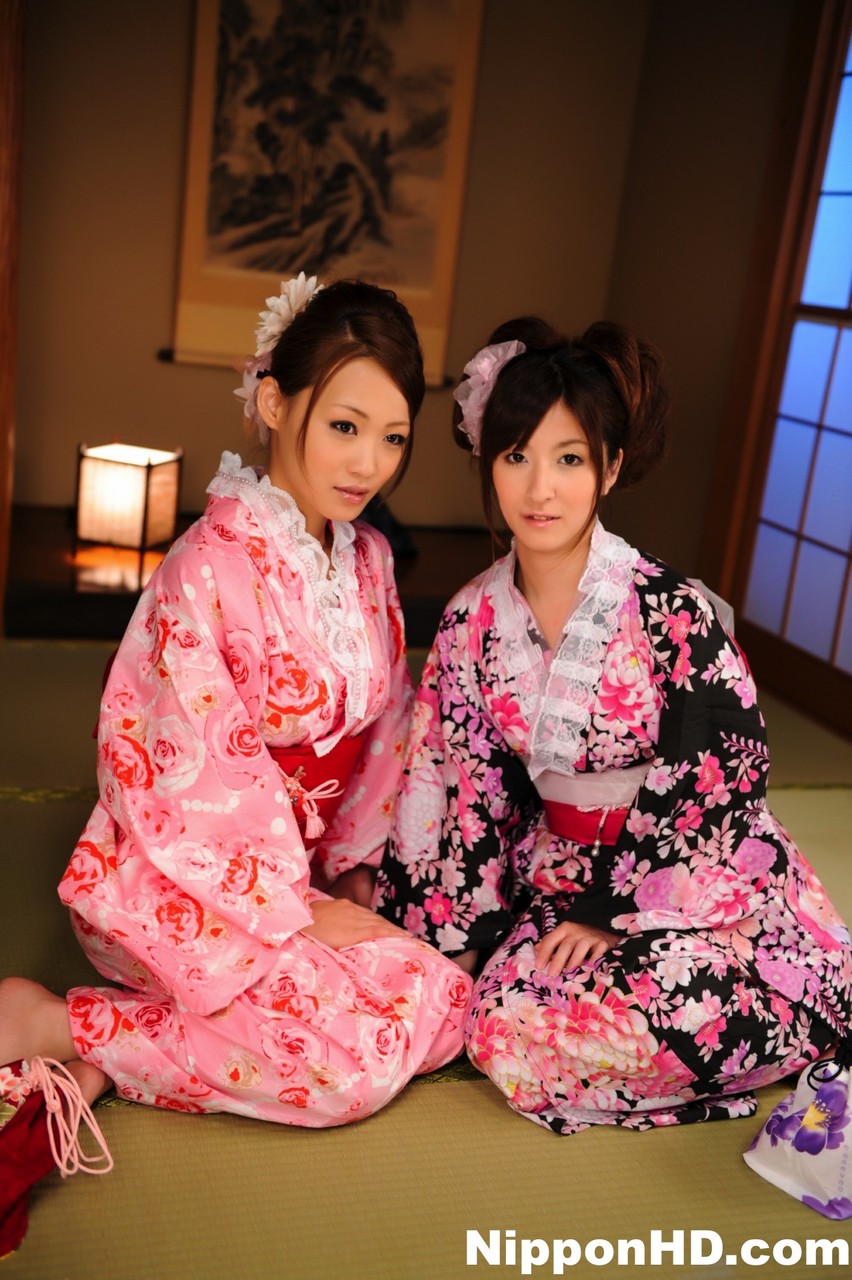 JAV A pair of Japanese Geishas model together in their brightly colored kimonos