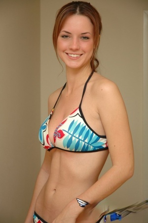 Young solo girl Amy wears a smile while posing non nude in a string bikini 90071691