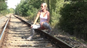 Blonde girl LickyLex pulls down her pants  squats to pee on the train tracks