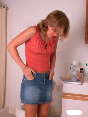 Amateur girl Karen hikes her denim skirt in the bathroom to expose her panties 99036682