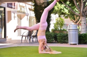 Young blonde Nikki gets naked after demonstrating her flexibility on lawn