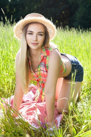 Teen first timer removes straw hat and clothes to model naked in a hay field 85923241