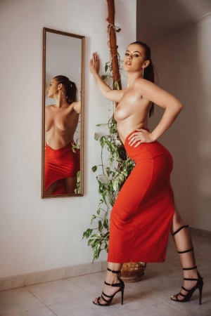Hot brunette Brook Wright unzips a red skirt to pose nude afore a mirror 11107267