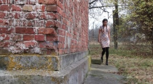 Nice girl pulls down black tights for quick pee behind a building