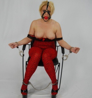 Thick blonde is kept in chains and a ball gag until its time to suck cock