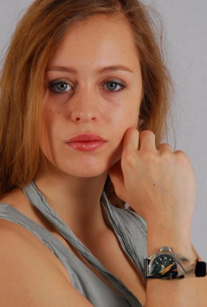 Pretty redhead Jennifer displays her Citizen divers watch while fully clothed