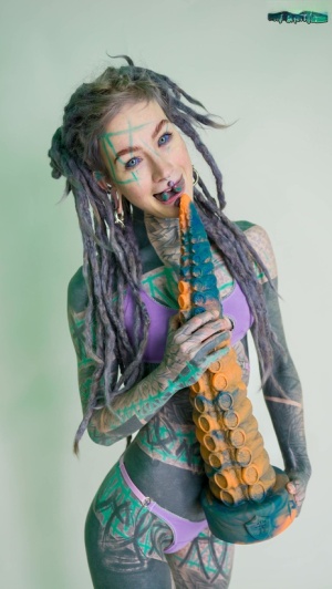 Heavily tattooed girl Anuskatzz holds a couple of taintacle toys in the nude 61932882