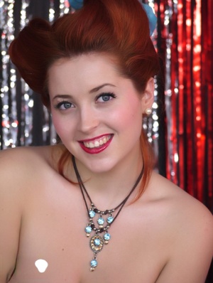 Gorgeous pinup model Lucy V strips burlesque style on a glittery stage