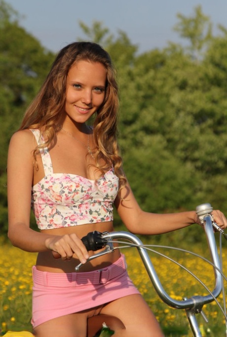 Cute teen Mango A gets naked in a field of yellows flowers during a bike ride 81774636
