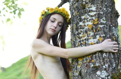 Skinny teen Lapa wears a crown of flowers while posing naked in a meadow 53811929