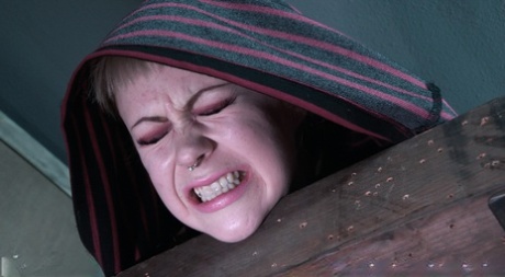 Blonde girl Anna Tyler grimaces in pain while being tortured in a dungeon 59636960