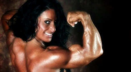 Dark-haired bodybuilder Debbie Bramwell flexes her muscles during SFW action 38693332