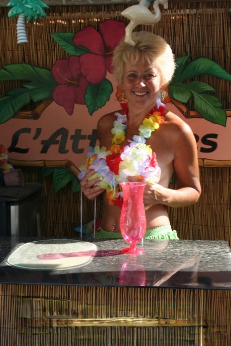 Mature woman Tracy Lick frees her horny cunt from grass skirt at swing club 73109447