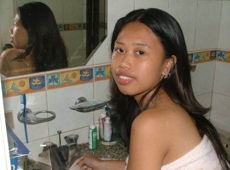 Asian amateur takes a pee on a toilet after being caught naked in a shower 39387880
