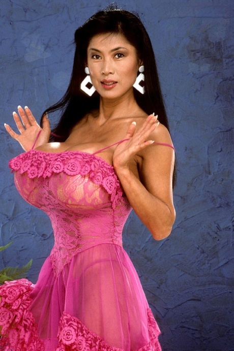 Older Asian model Minka set her giant tits free from ruffled dress 40452692