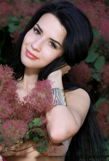 Brunette teen Lola Marron strikes great nude poses in front of bushes