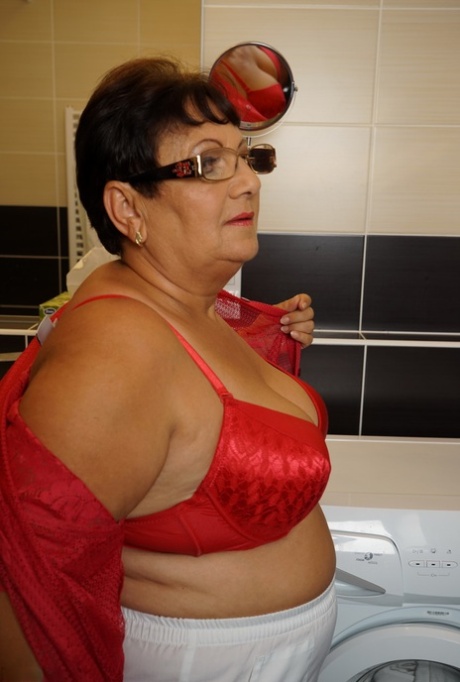 Overweight old woman is bathed by her toy boy while in the bathtub 55706278