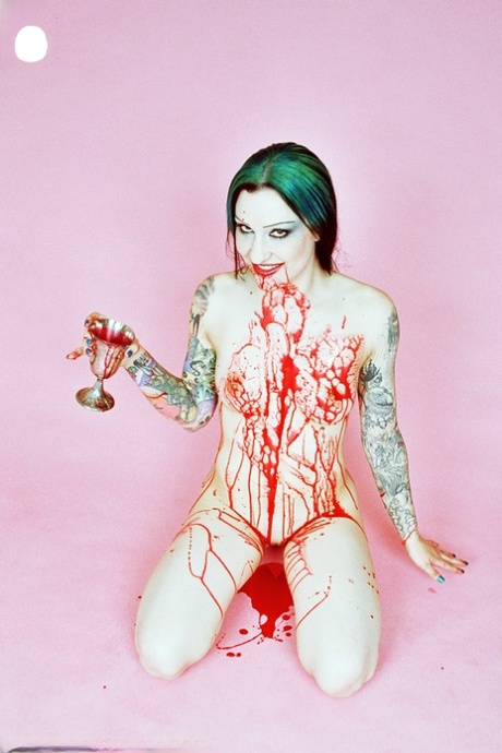 Tattooed girl Jen Vixen covers her naked body in fake blood at Halloween 14444760