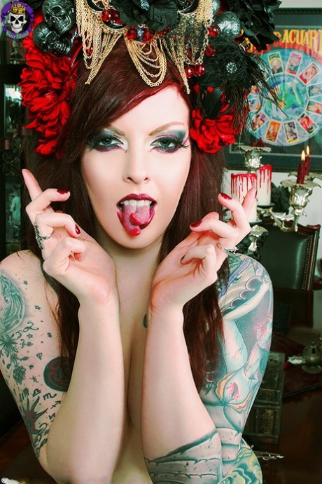 Inked redheaded Goth Penny Poison displays her split tongue during solo action 93368286