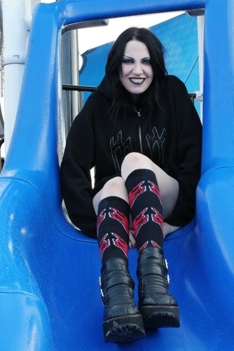 Goth girl Charlie exposes her upskirt pussy on a public playground 27669295