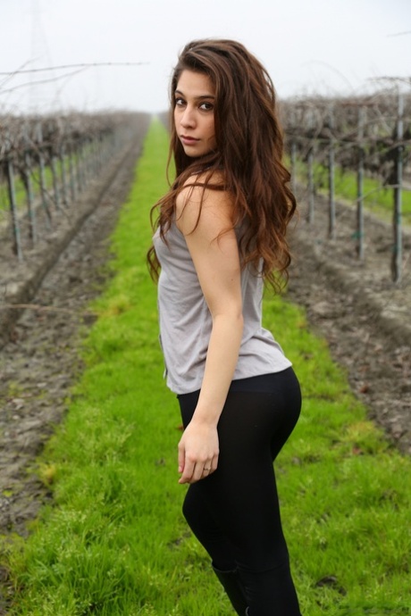 Amateur girl Ally Milano exposes thong covered ass between rows of grape vines
