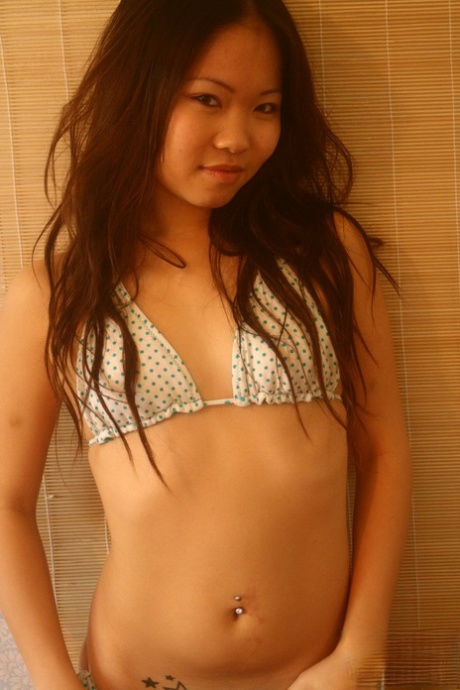 Adorable Asian teen Grace undoes her bikini top in a teasing manner 84359983