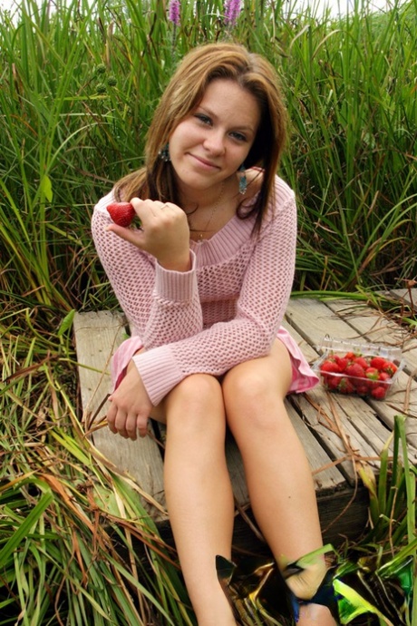 18 year old munches on strawberries after exposing her panties in long grass
