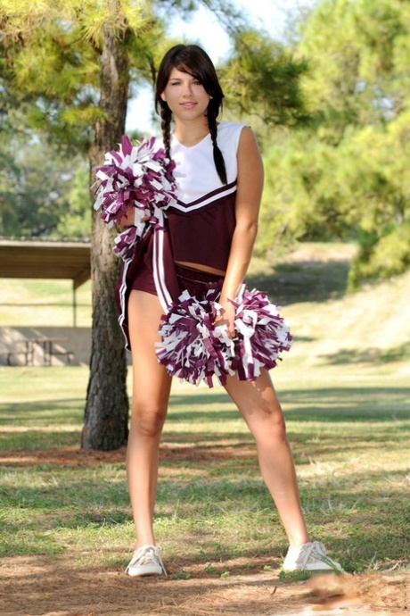 Dark haired girl Shyla Jennings lifts up her cheerleader skirt on a lawn 17806520