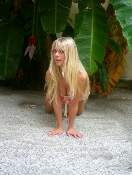 Natural blonde Jana Jordan bares her ass while wearing a bikini near greenery 58797575