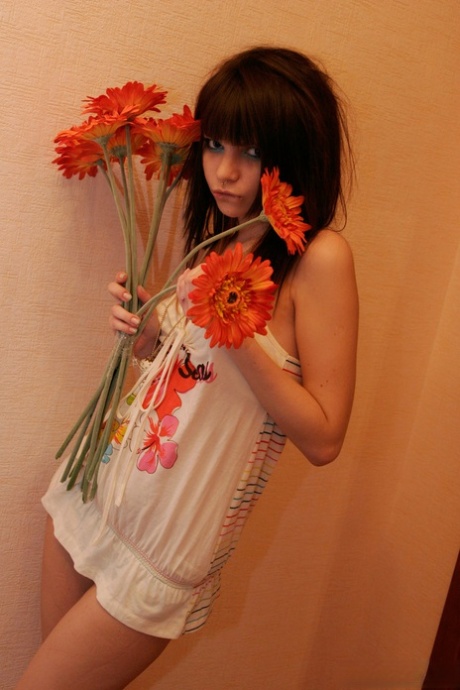 Charming teen Kaira 18 holds a bunch of flowers during a non nude shoot 85783672