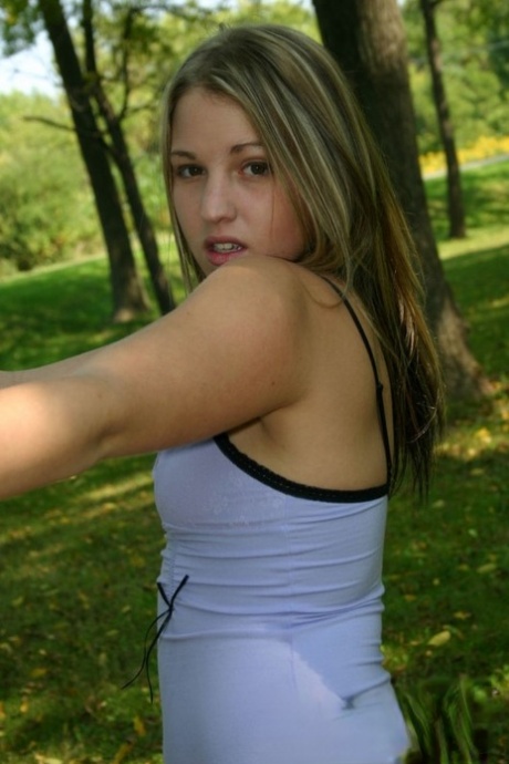 Amateur teen goes for a walk in the park attired in a short dress 37501079