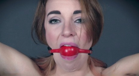 White teen Kate Kenzi has a ball gag removed before a rope suspension scene 94258142