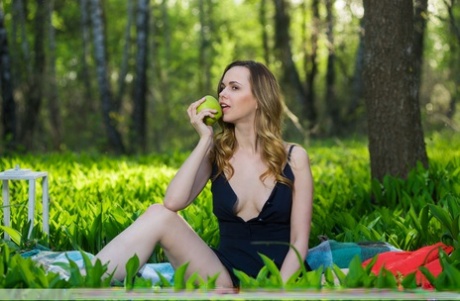 Solo girl Nasita holds a green apple while going nude near a forest 32795126