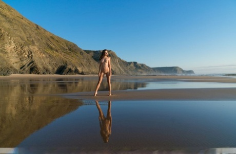 Beautiful girl Lauren wanders a mud flat at low tide without any clothes on 46726907