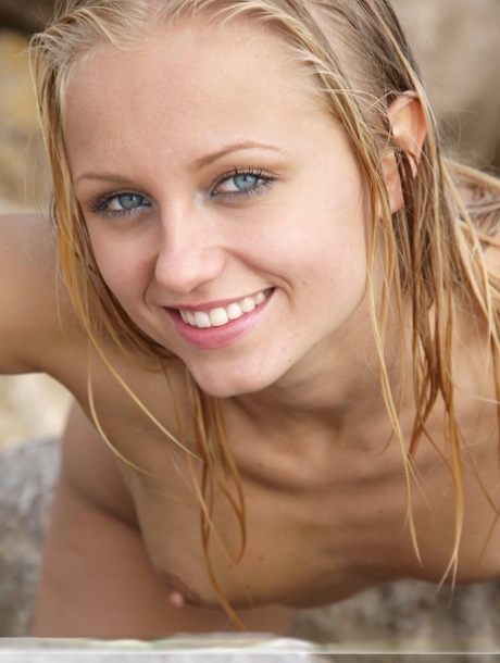 Thin blonde Hella removes her swimsuit to model naked and wet on seaside rocks 46287274