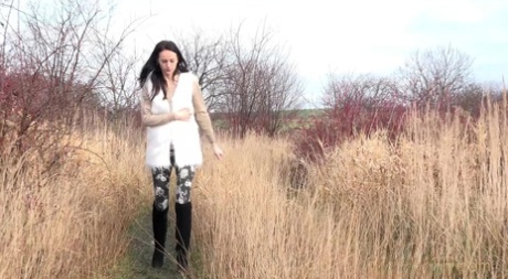Eveline Neill squats for a piss while walking on a path in the countryside 35266695