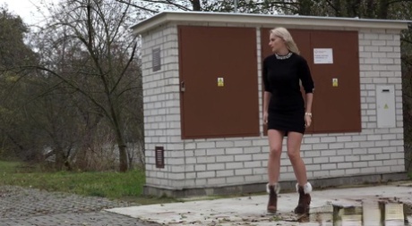 Blonde girl Katy Sky takes a piss on a concrete pad in winter boots 93723966