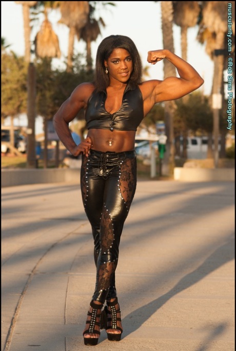 Black bodybuilder Jaquita Persons Taylor flexes while walking her dogs 48119249