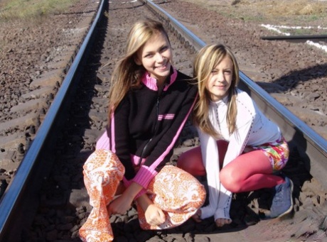 Teen lesbians Katrina & Laura expose their tits while wandering railway tracks 90228040