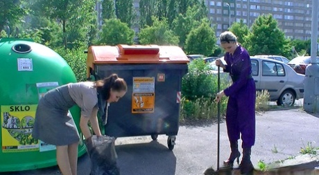 Two housewives cover each other in food products near garbage bins 25083662