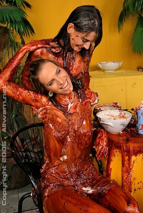 Fully clothed women cover each other in extremely messy food items 85194580